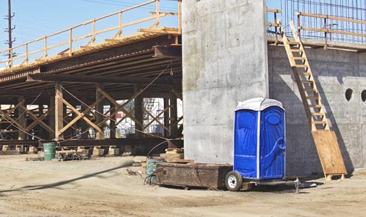 porta potties lined up neatly, ready to serve construction site workers